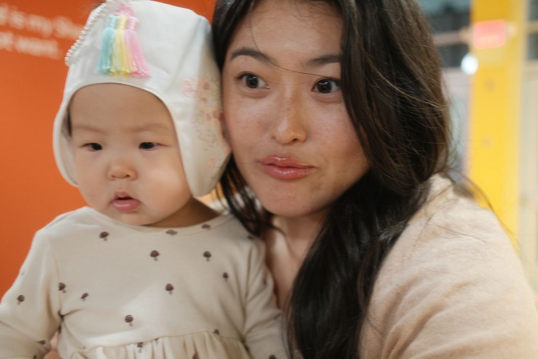 Mother and baby against a warm orange wall