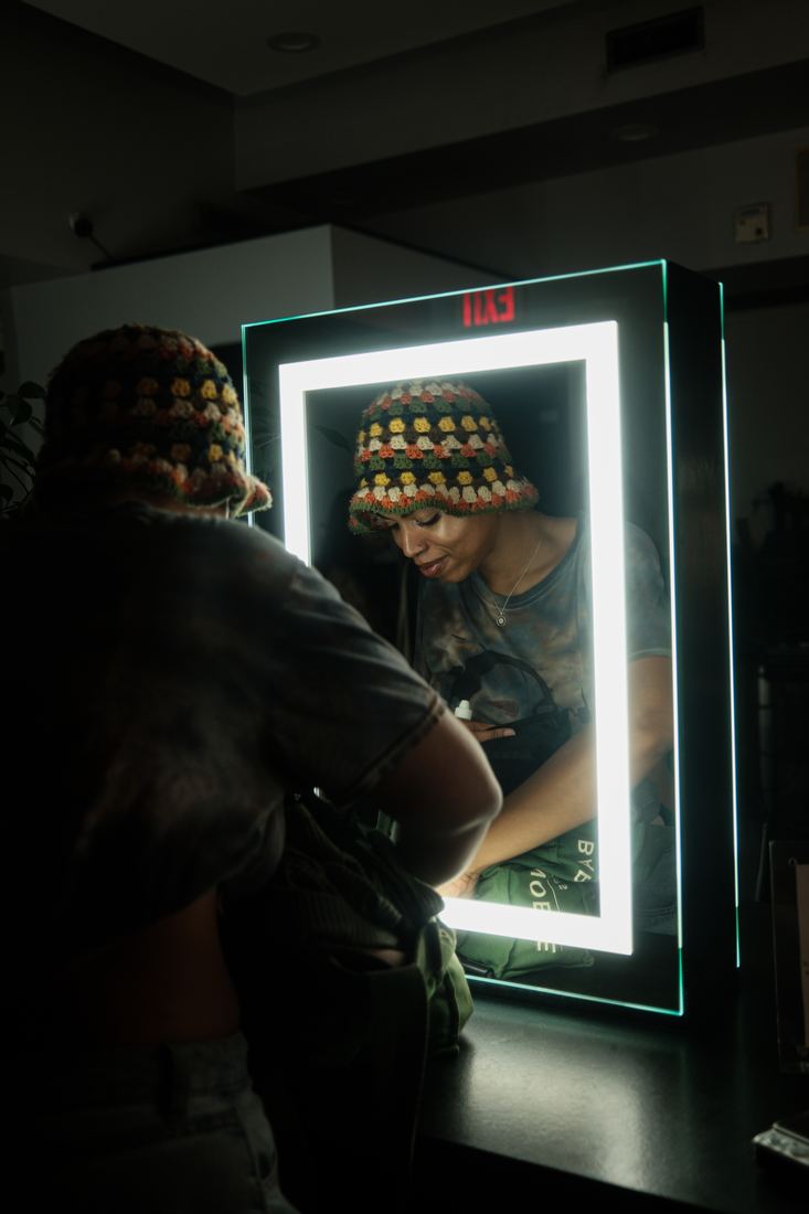 A guest at an illuminated mirror