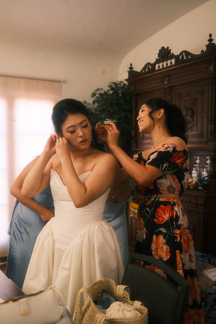 Bride getting ready, adjusting an earring