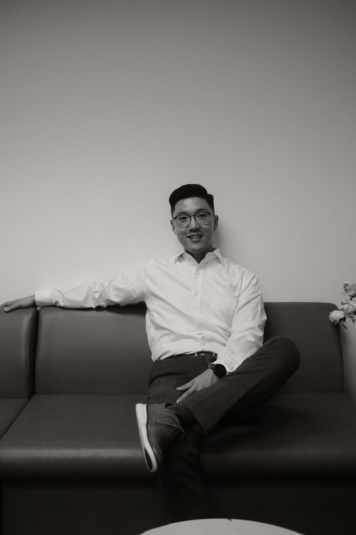 Seated portrait on a sofa, black and white
